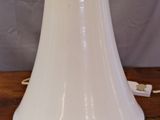 an image of a white lamp on a wooden table