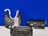 three purses and a handbag are sitting on a table