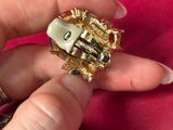 a person holding a gold ring with a lock on it