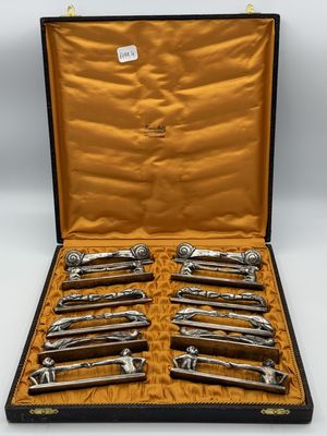 a set of six silver plated wine openers in a leather case
