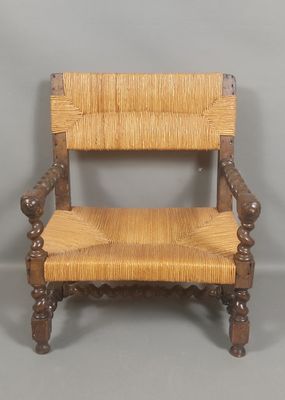 an image of a wooden chair with a woven seat on a gray background