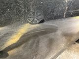 a black car with yellow paint on the side of it