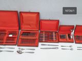 many different types of silverware in a red case