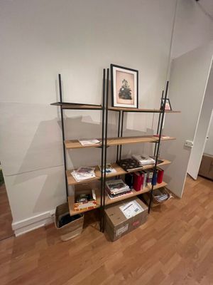 a room with a wooden floor and a bookshelf