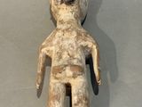 an old wooden doll with a helmet on it ' s head