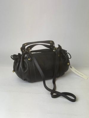 black leather handbag on white background with price tag