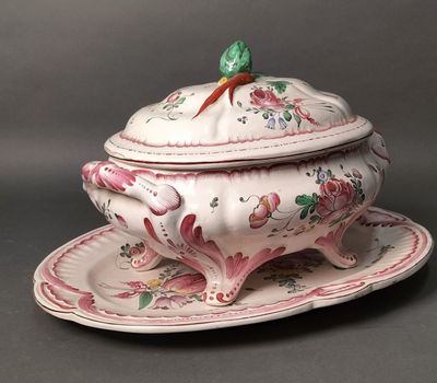 a white bowl with a bird on top of it on a plate