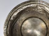 a silver bowl that is sitting on a table