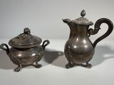 pair of antique silverplated teapots and saucers