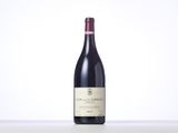 a bottle of red wine sitting on top of a table