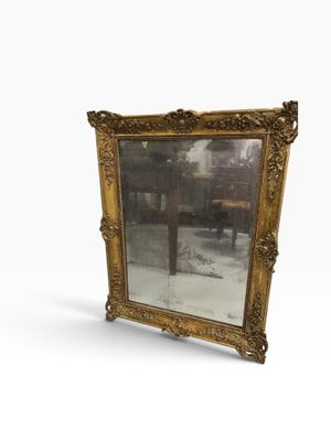 an antique gold framed mirror on a white background