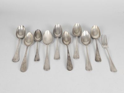 six silver spoons and a fork on a white surface