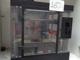 a machine that is sitting on a shelf in a room