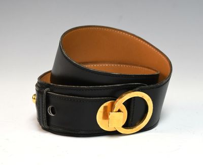 a close up of a black leather belt with a gold buckle