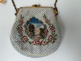 a purse with a picture on it hanging on a wall