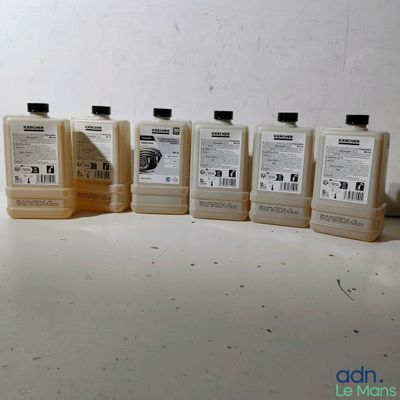 several bottles of liquid sitting on a table with a white background