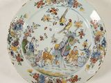 a plate with a bird and flowers design on it