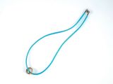 blue cord necklace with a silver clasp on a white background