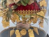 a glass clochet with flowers inside of it on a table