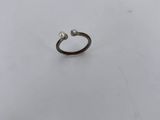 a single pearl ring on a white surface