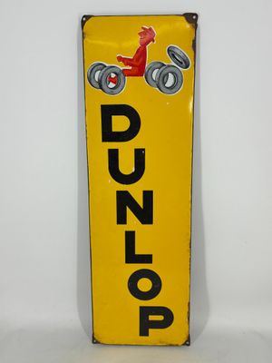 a close up of a yellow sign with a red car on it