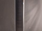 a black tower fan sitting on top of a wooden table