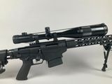 a rifle with a scope mounted on top of it