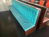 a bench with a blue cushion in a restaurant