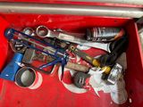 a red tool box filled with tools and other items