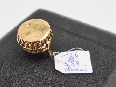 l'image d'un anneau d'or surmonté d'une pièce de monnaie