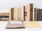 several books are stacked on top of each other on a table