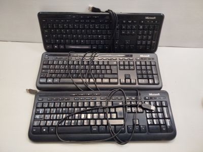 two keyboards and a mouse sitting on a table