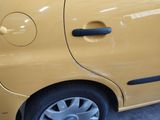 a small yellow car parked in a parking lot