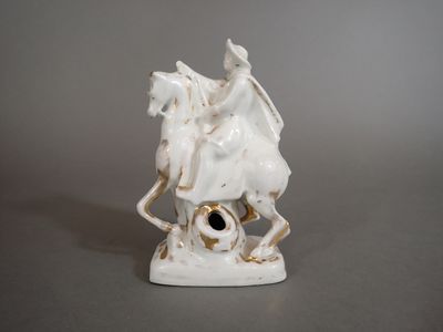 a statue of a man riding a horse with a bird on its back