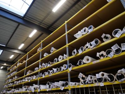many rolls of toilet paper on the shelves in the warehouse