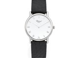 a close up of a watch on a white surface with a black strap