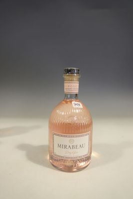 an image of a bottle of pink wine sitting on a table