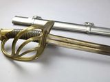 a close up of a sword on a white surface