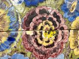 a painting of a flower on the side of a wall
