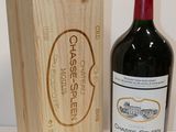 a bottle of red wine next to a wooden box