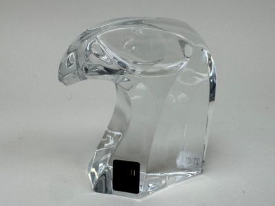 a glass sculpture of a bird on a white surface