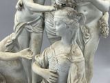 a statue of a man and a woman with a dog