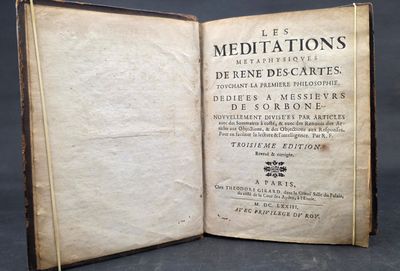 an old book opened to reveal a page of text on a black background