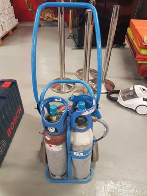 a blue cart with two cylinders on it in a room