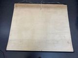 an old piece of paper hanging from the ceiling with a person standing in front of it