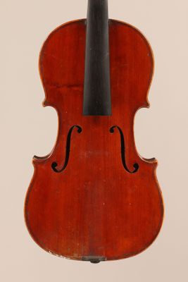 an old violin with a bow hanging from it ' s back