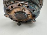 a close up of a metal object on a white surface