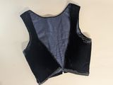 a close up of a black leather vest on a white surface