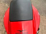 a red motorcycle parked on the side of the road