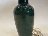 an image of a green vase with a monkey on it